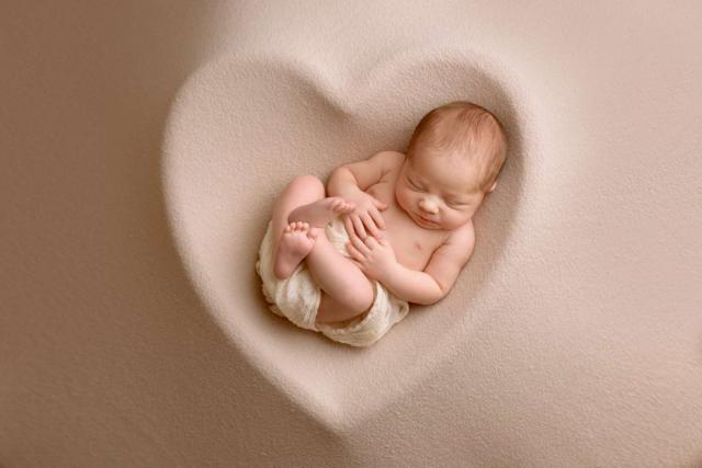 Newborn baby sleeps during the photo shoot in Berlin